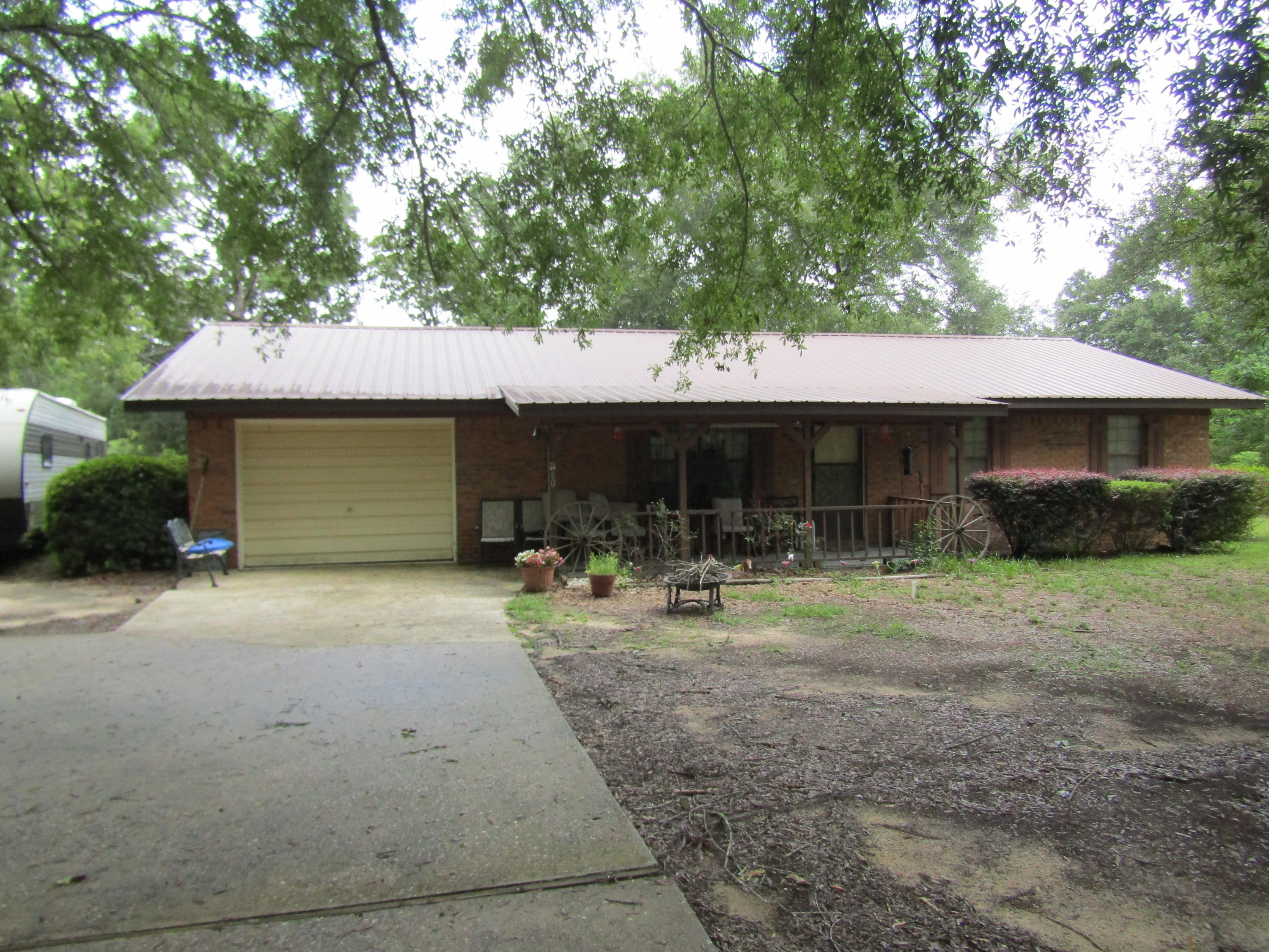 Bring your horse to this beautiful country home that is in a great location. It is south of the interstate on Coy Burgess Loop so you are close to Freeport and the beaches. This beautiful brick home with a metal roof has 3 bedrooms 2.5 bathrooms, garage, and large sun room overlooking the back yard. The yard is fully fenced with two horse paddocks, run in shed, and a barn/ mancave with water and electricity and a horse stall. The property is bordered by 3 roads so you only have one neighbor in the backyard.