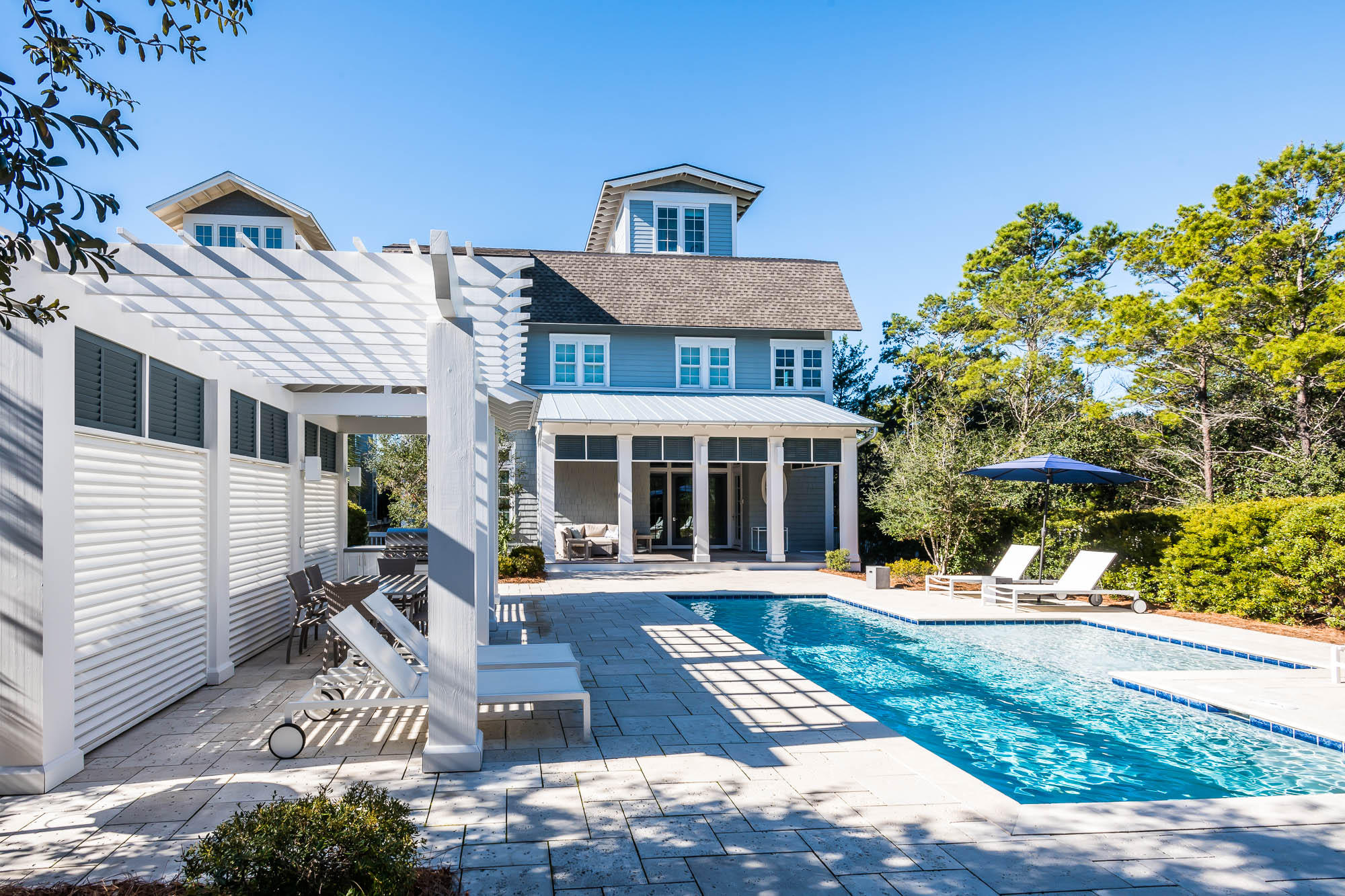 Perfectly positioned on one of the largest homesites in WaterSound Beach and offering breath-taking panoramic Gulf views, this 7-bedroom beach house boasts unmatched outdoor space perfect for hosting guests or large family gatherings. The expansive courtyard offers a spacious pool deck with a large pool, a pergola with an outdoor dining area and a covered summer kitchen. The entry, finished in shiplap, asserts soaring ceilings and beautiful tile flooring that transports you to an additional living room adjoined to two king bedrooms with ensuite baths. Off of the living room extends an expansive screened porch that provides additional coveted outdoor space. Adjacent to the foyer is a guest bedroom with an attached bath and a spacious double bunk room. Offering a fun and functional reverse