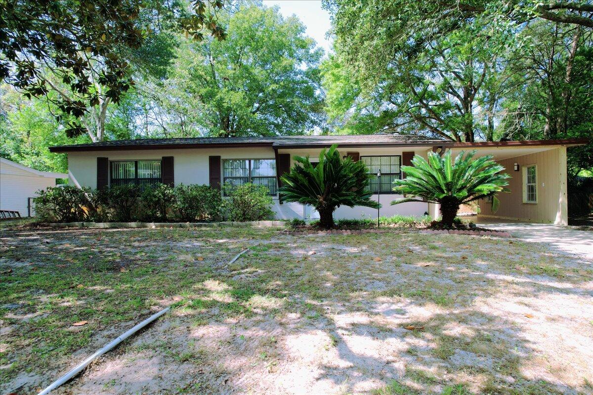 *Back on market no fault of seller* This charming home is a must-see, located just a few miles from the park, elementary and high schools, and minutes from the military base and the beach. This home offering three bedrooms and one bathroom, including fresh siding for the carport, a roof replacement in Nov 2022, and the AC in Mar 2020. Tile flooring in the kitchen, bathroom, laundry room, and dining area, while the living room and bedrooms are carpeted. The laundry room is generously sized, and the washer and dryer are conveyed in AS-IS condition. The fenced backyard offers privacy, thanks to the shade from the trees. An open concrete patio provides the perfect spot for outdoor grilling or simply enjoying sunny days. Additionally,