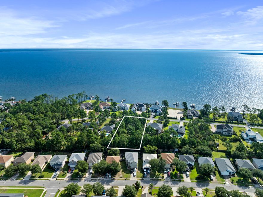 Build your dream home on this exceptional 0.64-acre homesite located in the highly sought-after Driftwood Estates community. Ideally situated just minutes from the pristine beaches of South Walton & Scenic Hwy 30A, this neighborhood offers an outstanding combination of convenience & coastal living. Community amenities include a swimming pool, scenic ponds, sidewalks, street lighting, parks, and beautifully landscaped common areas. Driftwood Estates is centrally located near Sacred Heart Hospital, top-rated schools, premier shopping & dining, entertainment venues, Sandestin Golf & Beach Resort, and Grand Boulevard. Situated within a half mile of the water, this homesite offers bay views, providing the perfect setting to enjoy morning coffee & evening sunsets from your coastal retreat!