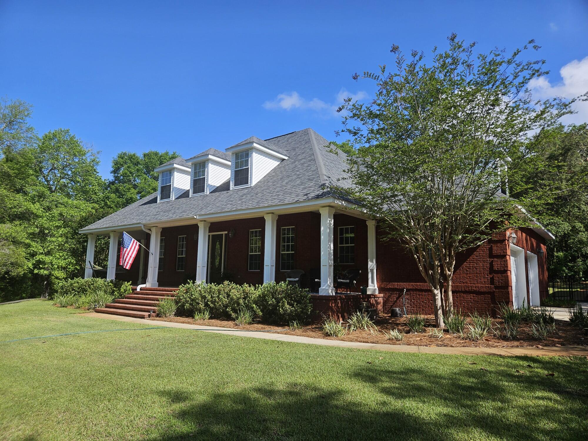Live the life of luxury in tranquil, private surroundings only 8 minutes from Destin's beautiful beaches, shopping, golf, dining, water parks, and more. This executive home is located in Lake Pippin Estates of Niceville, a private community with a bayside park and picnic area only 18 minutes from EAFB. This home was built in 2006 to the highest of building standards on a one-acre lot. There is room for everyone and then some! The main house with nearly 3700sf features 5 bedrooms, multiple living areas and 3.5 baths. The ADDITIONAL 1200sf workshop/garage with finished living quarters above to serve as a guest house, mother-in-law suite, office, etc.! This southern style home greets you with a wide wrap around front porch and elegant columns. Upon entering this fine home, you will find the living room located on the left and the dining room on the right. Just beyond these rooms are the family room and amazing kitchen. The family room with high ceilings and hardwood floors is accented by built-in bookshelves and a cheery fireplace. The family-sized kitchen features a large breakfast room open to a custom kitchen with granite counters, cherry cabinets, tiled floors and upgraded stainless steel appliances. The master bedroom suite is also located on the first floor. The master bath is true luxury with a large whirlpool tub, separate shower, dual sink vanity AND a dressing area with a make-up vanity and a large walk in closet. On the second floor of this home, you will find 4 LARGE bedrooms, 2 full baths, a good sized loft that is the perfect place for the family computer and an abundance of storage space. The outdoor living facilities are almost as impressive as the indoor ones! Off of the rear of the home is a screened-in gunnite pool and hot tub that look out over the Eglin reservation offering complete privacy! Just off the right side of the house, sharing the driveway with an attached oversized 2-car garage, there is ANOTHER 2 car garage/workshop with additional finished living quarters above. Extra insulation is in place between the first/second floors and in interior walls. Termite bond in place. If you want to live the life of luxury while still enjoying country living, this home is for YOU!