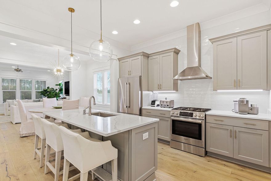 Prepare to be impressed by this charming residence nestled in the Watersound Origins neighborhood. Perfectly situated on a premium lot, this Huff-built home backs onto a tranquil pond and mature forest, providing ample privacy and tranquility. To the front, a two-car garage and covered front porch look out onto a peaceful neighborhood park. Step inside this pristine home and be greeted by the warm medallion wood flooring and other luxury details including solid core doors, a dry bar, upgraded tile, 10-foot ceilings and crown molding throughout. The open concept promotes social connectivity and a welcoming atmosphere, with ample space for entertaining. The heart of the home lies in the stylishly designed kitchen. High-quality stainless steel appliances