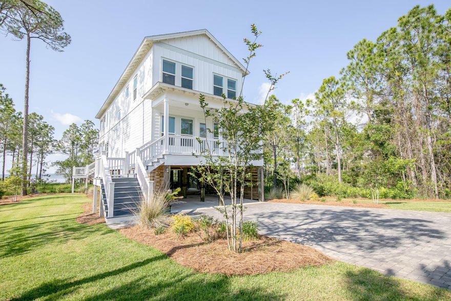 Enjoy life on the bay in this beautiful 4 bedroom, 3.5 bath home with abundant outdoor entertaining areas, a private beach and a custom covered boat house. The home features high end finishes, an open living design and amazing views of the bay. The main floor hosts the guest bedroom suite, a half bath, and the open concept kitchen, living and dining areas. The large balcony is perfect for outdoor dining. The master suite, two additional bedrooms and another full bath are located on the top floor. The master boasts a huge balcony as well. Located in Eagle Bay Landing, you get the best of both worlds with a small community surrounded by nature. There's plenty of space to store and launch your boat, kayaks, wave runner, etc. This awesome 2820 sq. ft. home sits on .91 acre with 116 ft. on bay