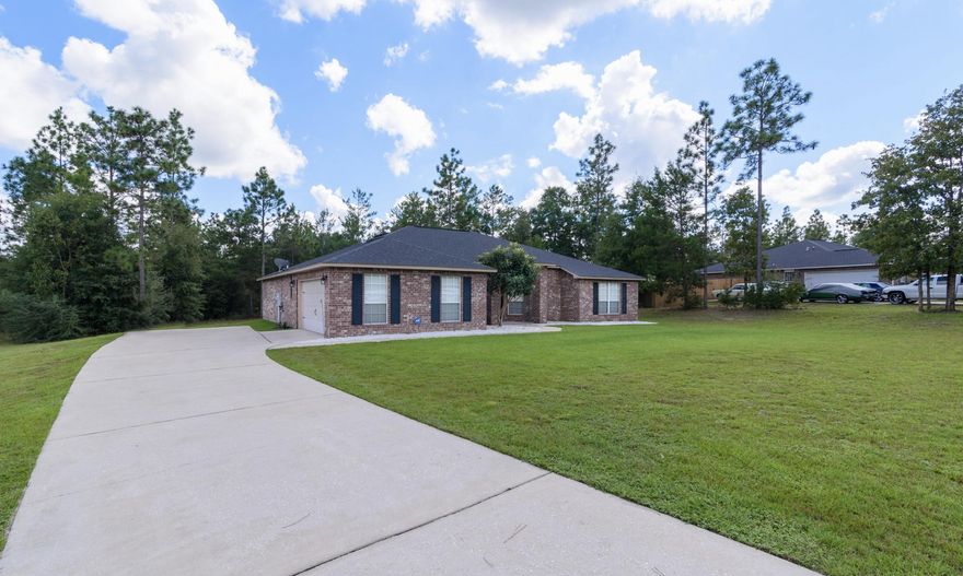 ONE ACRE LOT with an ALL BRICK BEAUTIFUL HOME! If you've been looking for privacy, space and an abundant yard you've found it! This gorgeous, partially cleared acre is like having your own retreat. The over extended driveway has the capacity for any parking desire including a boat or RV.Inside you will be greeted with gorgeous hardwood bamboo floors throughout the living area. A nice sizable den and grand dining room has wonderful natural light with updated fixtures. The spacious living room with vaulted ceilings is open to the attractive tile floored kitchen and breakfast area. The kitchen boasts granite countertops, custom cabinetry and tiled back splash, stainless steel appliances and a great island for plenty of countertop space.