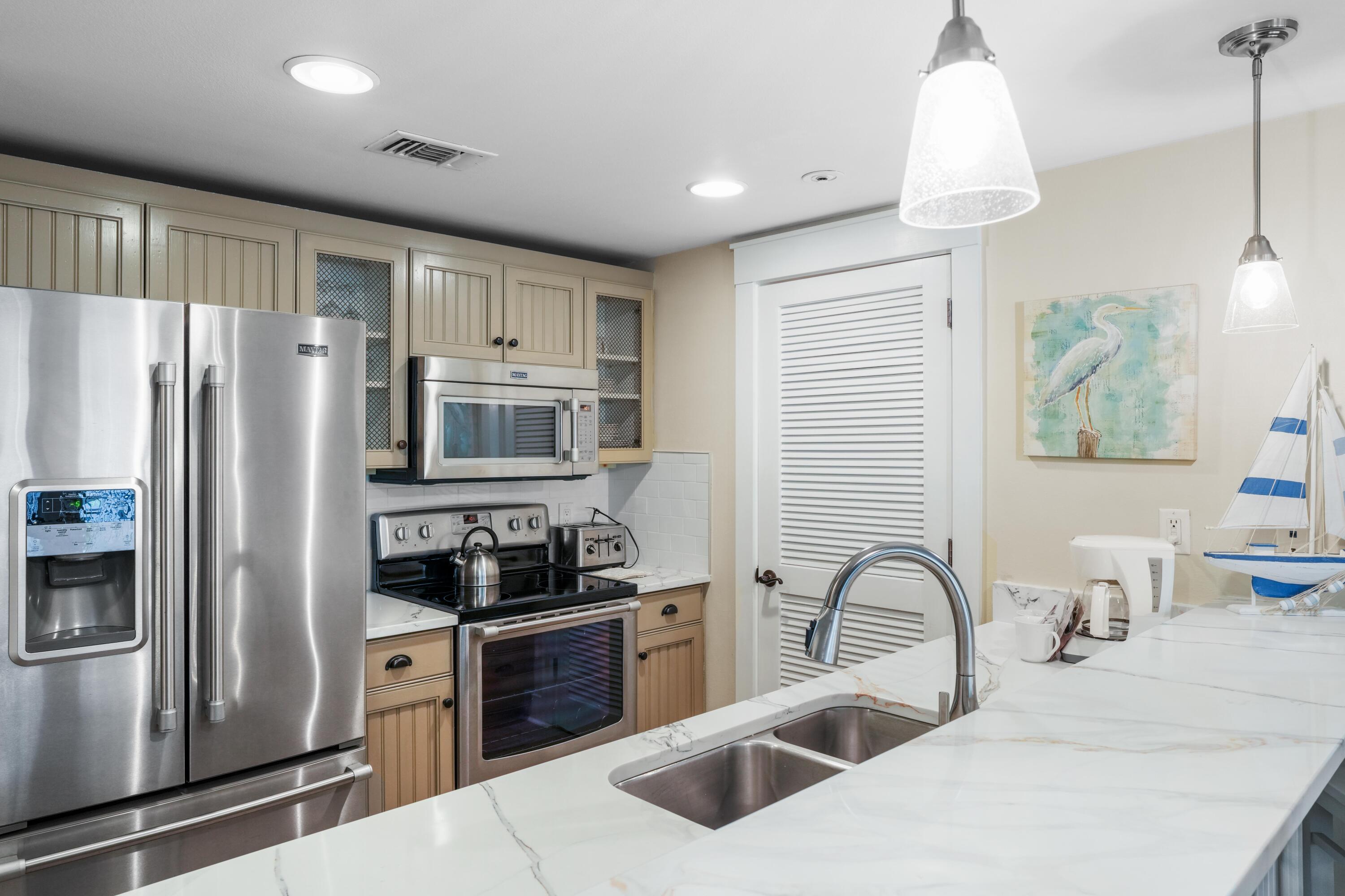 Enjoy a relaxing retreat in the heart of Baytowne Wharf. Sip your favorite drink while listening to music from your spacious balcony, which overlooks beautiful landscaping. This beautifully updated Market Street Inn condo is situated in the Village of Baytowne Wharf. It features a lockout option for maximum rental potential.Recently, this pristine condo has been completely repainted, including all kitchen and bathroom cabinets. The flooring has been upgraded to stunning wood grain tile planks, and both HVAC units have been replaced. New smart TVs, along with new furniture and decor to enhance rental appeal.This resort home is conveniently located near shops, restaurants, and the beach!  Priced to sell fully furnished and rental ready, or you can choose to keep it for yourself.