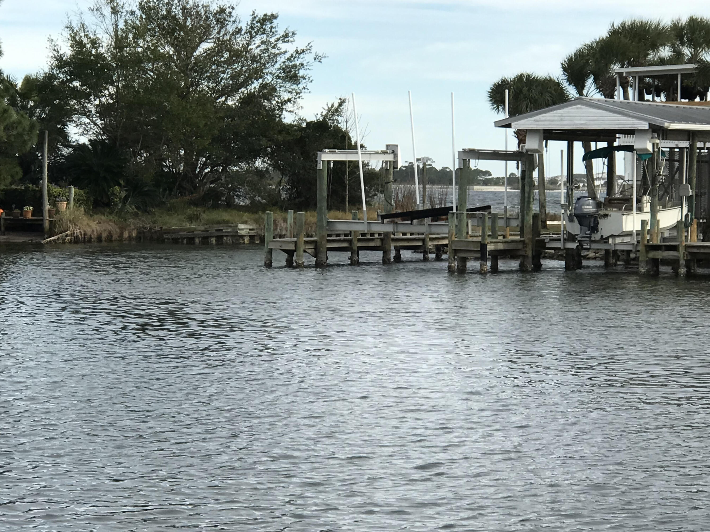 Want to go fishing and boating in the Gulf, the Bay or the Sound from your home? This 4 bedroom water view home offers amazing views of the Bay and sits close to downtown Fort Walton Beach. There is deeded dock access at the south property line to walk to the dock allowing you boat access to the Bay. You can also put your boat in the water next door. Watch the boats go by during the day and in the summer see the Fort Walton Beach fireworks from the covered porch. Golf carts are allowed in the area to go enjoy local food, parks and festivals. This water view home has neutral colors and offers views from most rooms. There is a large upstairs room that can be a 5th bedroom, office or an entertainment room. Storm shutters & roof 2017.