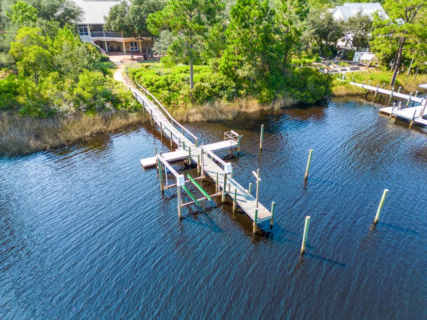 Water front living, exquisite architecture and creature comforts combine to produce a living experience for the most discriminating buyer. Your updates will combine with great bones to produces a one-of-a kind home on the bayou. One full acre of landscaped grounds can be trimmed to reveal a full 100' of frontage on the widest portion of Hewitt Bayou and a private dock with lift. This home's more than 9000 square feet of total living space includes over 2400 square feet of tiled balconies and patios which span the entire length of the home. Water views are maximized from every vantage point. This Sater Home Design custom built home seamlessly blends outdoor and indoor environments. The home's exterior is casually grand in the style of Old Florida living. The home's interior is well
