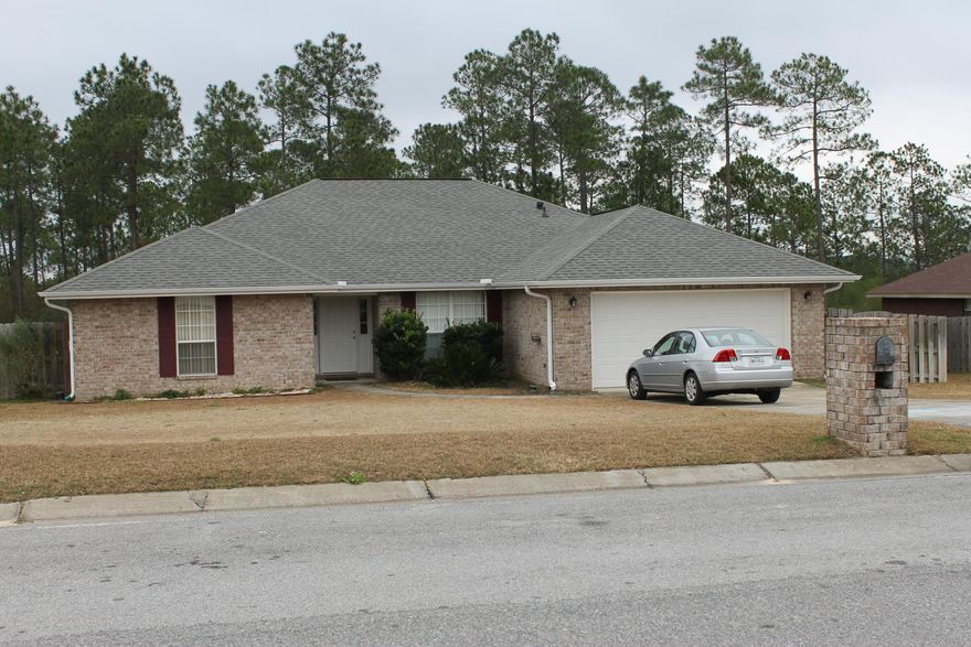 MOVE IN READY! South of I-10! 2100+ sqft never felt so spacious! This open split floor plan,with Jack & Jill bath allows each bedroom it's own bath. Perfect for larger family needs. Family room has fireplace, formal dining or office, eat in kitchen are all features that cater to family life, location caters to quick commutes to & from bases! Spacious laundry room, 2 car garage and large covered back deck are just a few items that make this house worth calling home! Don't wait!!!