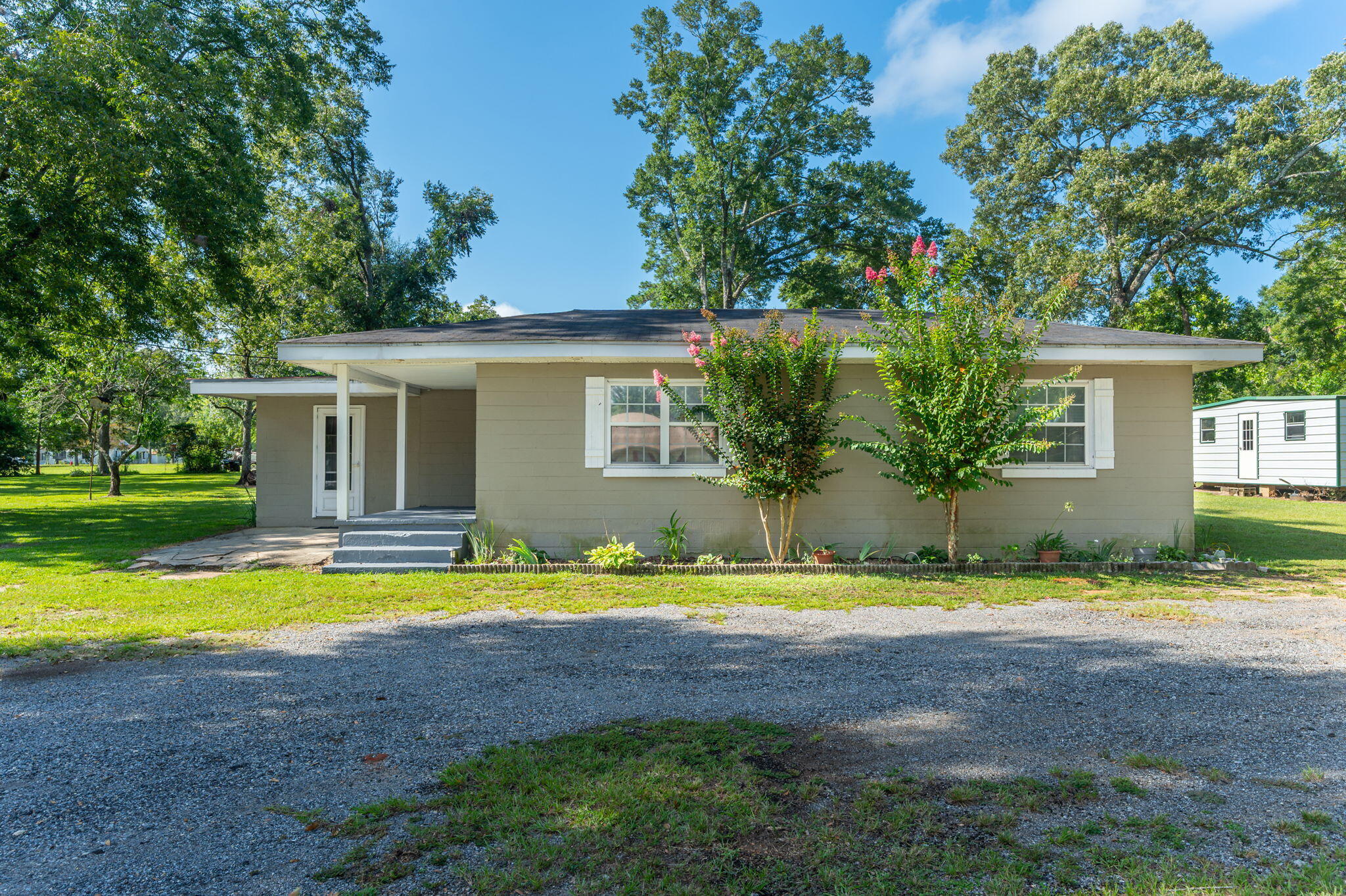 Move in ready 2 BR/1BA solid built home located just blocks from Lake Jackson with almost a 1/2 acre yard. Home welcomes you with a circle drive, large oaks, maintained yard, flower beds and tons of room to garden and a large covered storge barn in back yard. Home uses every ounce of square footage offering a large open floor plan that includes a large living room, separate dining, and a great kitchen with tons of cabinets and counterspace. The home has two large bedrooms, both with plenty of closet space and ample room size. The updated full bath includes a walk-in tile shower, nice vanity and is centrally located between the bedrooms allowing easy access for guest! Home also offers a great covered front porch as well as attached large utility. Perfect for a starter home or to downsize.