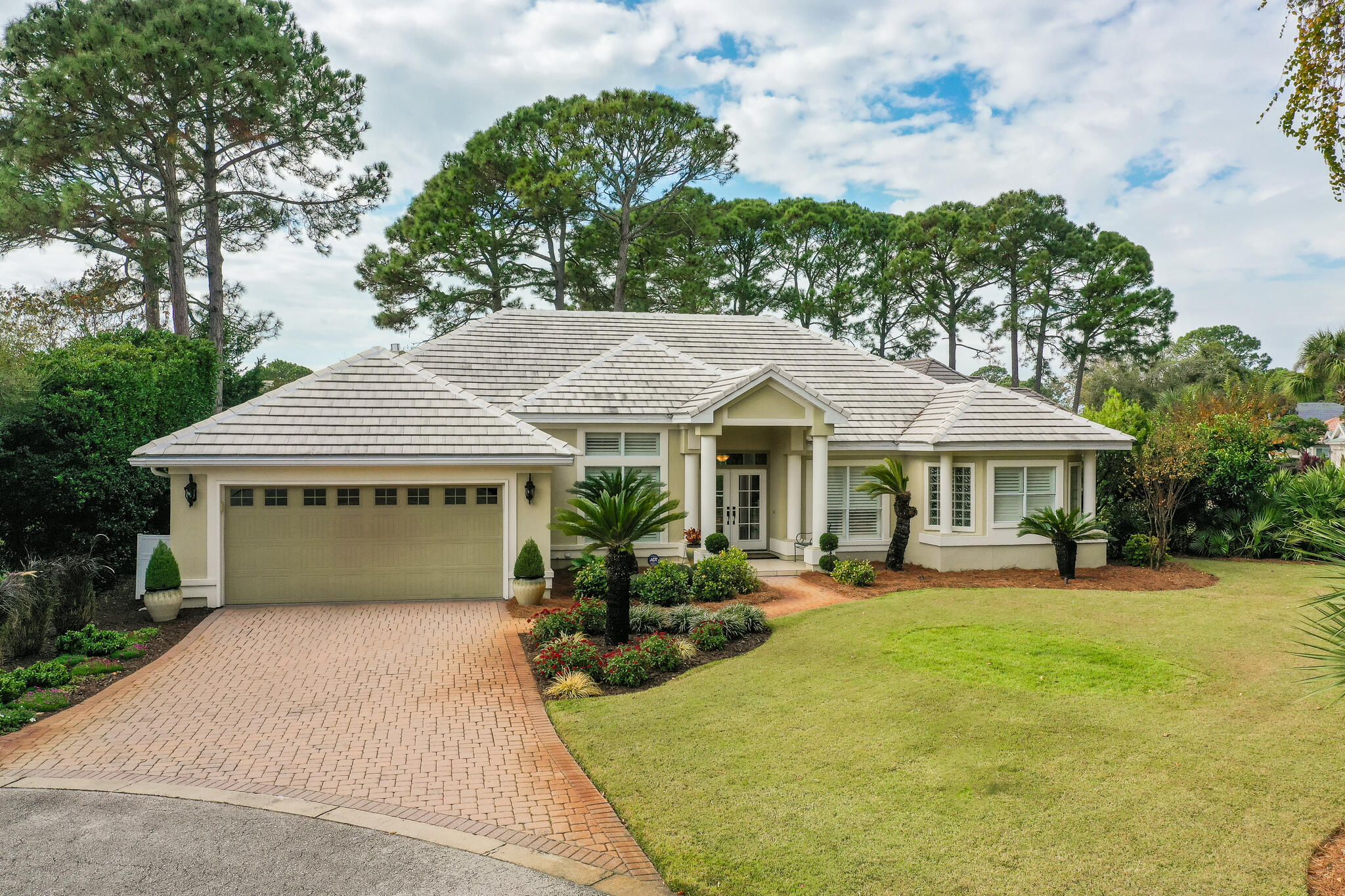 Exquisite Contemporary Home located in the gated golf course community of Emerald Bay. This immaculate split floor plan totally updated home features 4BR | 2.5BA and is nestled in a wooded area at the end of the cul-de-sac adjacent to the 5th tee box on Emerald Bay Golf Course. Upon entering the home you are immediately drawn to the abundance of glass that opens to the screened lanai, pool and hot tub. There is a half bath with access to the pool. The floorplan is perfect for entertaining with a large dining room and living room that opens to the pool, the kitchen is off of the living room and opens to the family room and eat in kitchen that overlooks the pool. The master bedroom is spacious and the NEW updated master bath creates a spa like setting which is truly Gorgeous!!