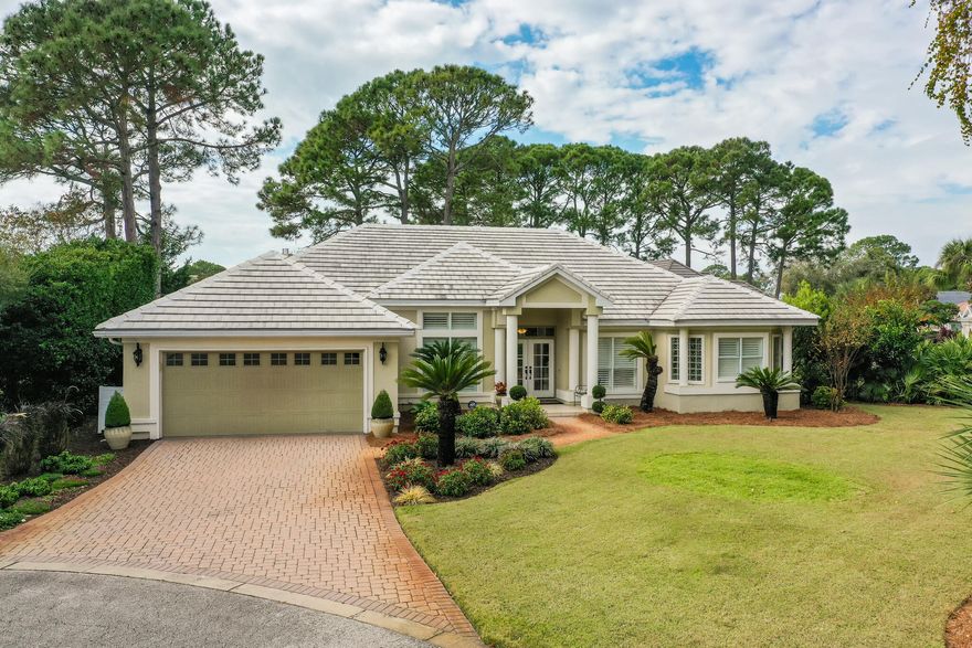 Exquisite Contemporary Home located in the gated golf course community of Emerald Bay.  This immaculate split floor plan totally updated home features 4BR | 2.5BA  and is nestled in a wooded area at the end of the cul-de-sac adjacent to the 5th tee box on Emerald Bay Golf Course.   Upon entering the home you are immediately drawn to the abundance of  glass that opens to the screened lanai, pool and hot tub.  There is a half bath with access to the pool.  The floorplan is perfect for entertaining with a large dining room and living room that opens to the pool, the  kitchen is off of the living room and opens to the family room and eat in kitchen that overlooks the pool.  The master bedroom is spacious and the NEW  updated master bath creates a spa like setting which is truly Gorgeous!!