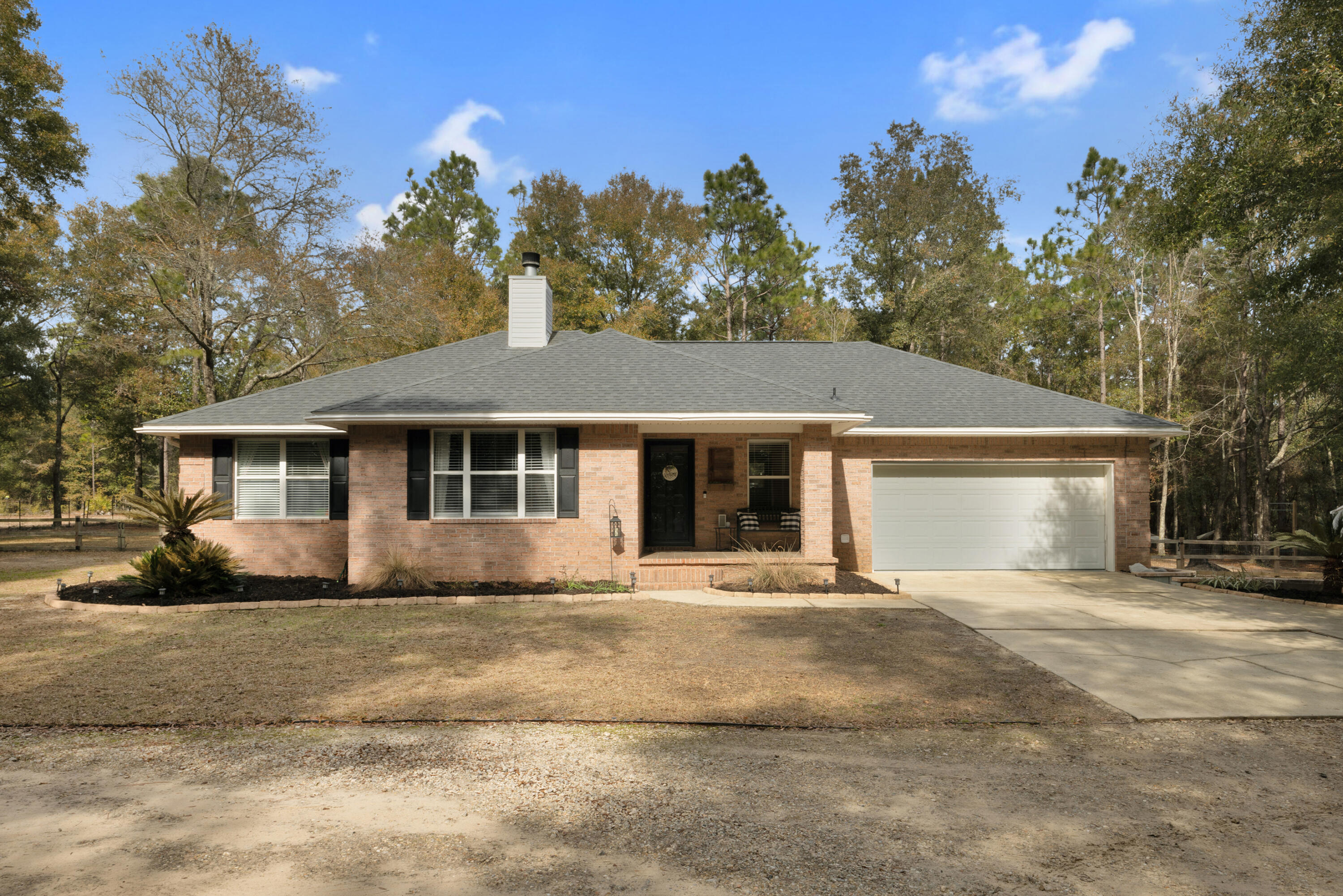 Don't miss this beautiful all-brick home nestled on 2.5 acres of peaceful surroundings! This move-in-ready property boasts a 2020 dimensional shingle roof, 2023 HVAC system, and a 2024 water heater--offering both modern upgrades and long-term peace of mind.Step inside to a bright and airy open floor plan, where the spacious living area features a decorative fireplace and flows seamlessly into the dining area. Sliding glass doors flood the space with natural light and provide easy access to the open patio, perfect for outdoor relaxation.The well-appointed kitchen features solid surface countertops, stainless steel appliances, and an upgraded faucet. A conveniently attached laundry room offers extra storage, including a pantry for overflow storage and a tuck-away ironing board. (con't) The Master Suite is perfectly sized, boasting a walk-in closet and a luxurious master bath with double sinks, a water closet, a separate garden tub, and a walk-in shower. Two spacious additional bedrooms and a guest bath complete the main living space.
Need extra room? A heated and cooled bonus room located behind the garage makes the perfect home office, hobby room, or additional storage area.
Step outside to your fenced backyard, complete with secure fencing, firepit, yard building and your very own chicken coop, perfect for homesteading or hobby farming!
This home offers modern upgrades, ample space, serene setting all in a prime location! 
