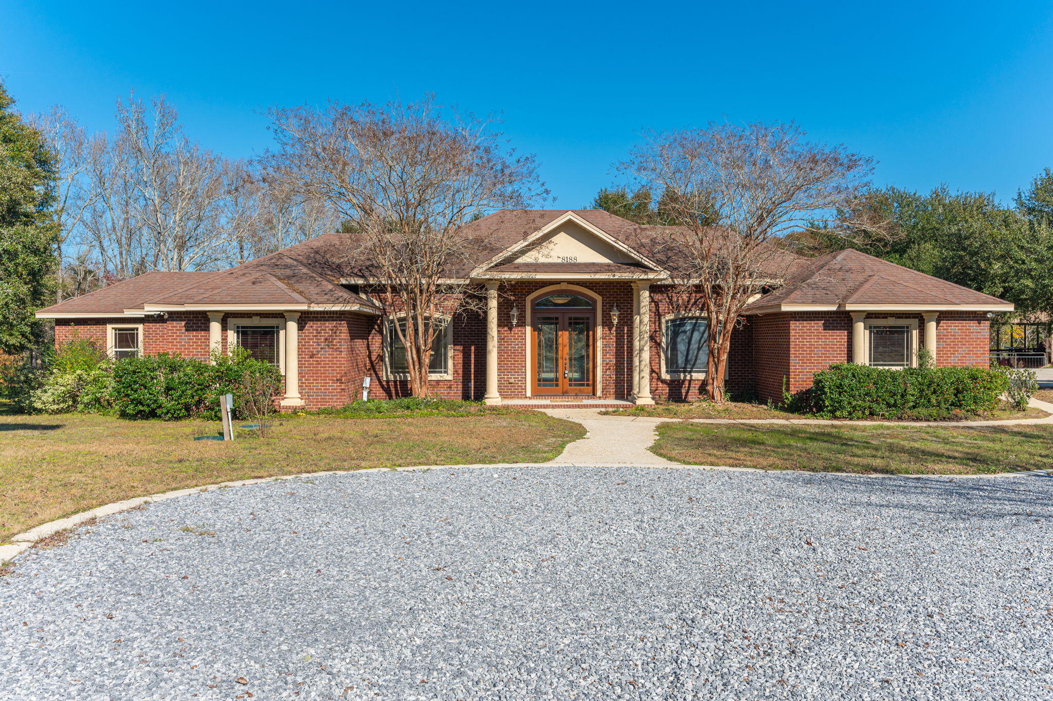 8188 Millers Street is a beautiful Custom Brick home built in 2006 on 5.03 ac. +/-. With 2771 Sf in the main house. The main house has three bedrooms, three bathrooms, a bonus/exercise room, an office, a screened-in back patio with a screen-enclosed pool, a barn with an in-law suite, with a full kitchen, two additional bathrooms, and so much more. This home was custom-built by a local contractor as a primary residence. The home boasts a grand foyer, hardwood and tile floors with custom designs. The double tray high ceilings, rotunda style accents and chefs kitchen are amazing.