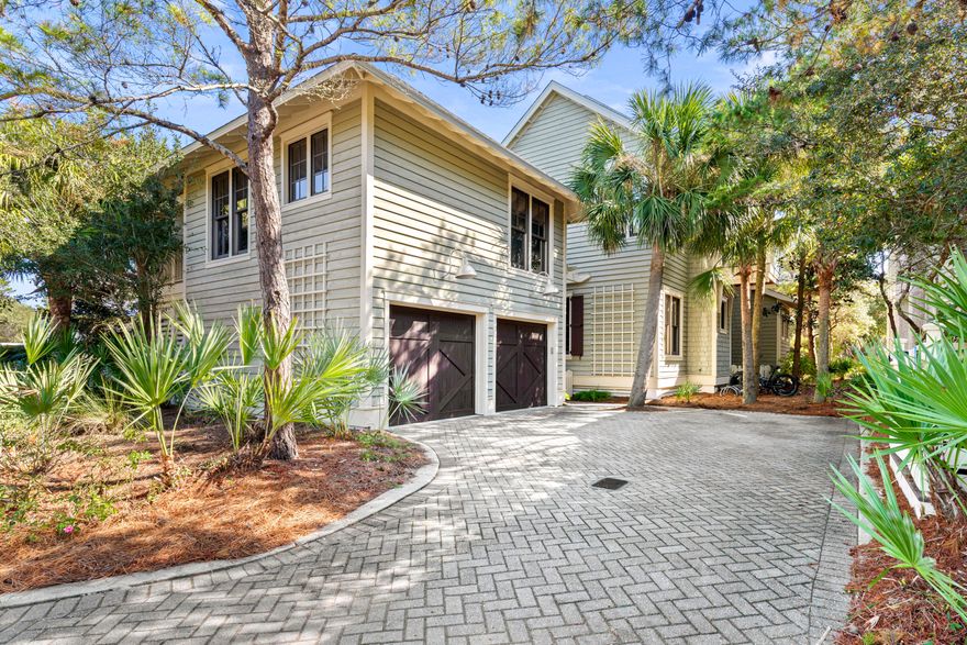 Just moments from the boardwalk and set in a remarkably private pocket of WaterSound Beach, this refined coastal retreat pairs serene dune and lake vistas with immediate access to community amenities. The setting is exceptional, framed by manicured green space at the rear, a pond across the street, and permanent views of Camp Creek Lake meeting the gulf's emerald horizon. Steps from the pool, outdoor lounge, and beach walkover, the home feels woven into its natural surroundings while offering the comforts of a full-time residence.Crafted with classic architectural details inside and out, the four-bedroom main home and detached one-bedroom carriage house create a rare, versatile offering. Two primary suites in the main home accommodate multigenerational living, while the carriage house  complete with a full kitchen and private bath  welcomes guests with its own sense of retreat. Throughout the residence, rich hardwood floors, vaulted ceilings, and thoughtful built-ins elevate every space.

The upper-level great room rises beneath warm wood beams and opens to an expansive balcony where views stretch across dunes, lake, and gulf. A granite-clad kitchen with custom cabinetry, Viking appliances, and a breakfast bar anchors this gathering level, with a wet bar positioned nearby for effortless entertaining. A gas fireplace, recessed lighting, and coastal textures set a relaxed yet refined tone.

On the main level, the primary suite enjoys wooded privacy and a screened porch with a stairway leading to the upper balcony. Two additional ensuite bedrooms, including one flexed as a secondary living area, offer comfort for larger groups. The second-floor primary suite features soaring ceilings, gulf views, and a Juliette balcony perfectly placed for sunset.

The carriage house above the two-car garage provides a beautifully finished extension of the home, ideal for long-term guests or rental potential. With WaterSound Beach's gated security, private beach access, boardwalks, parks, and pools steps away, this beautifully maintained residence offers a prime location, a practical floor plan, and a setting that feels both rare and restorative.