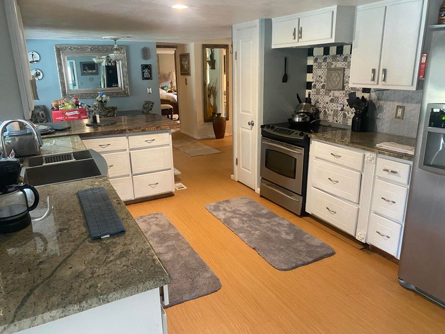 Don't miss this opportunity to own a spacious property with incredible potential in the peaceful and growing Wewahitchka area. This 2-bedroom, 2-bath mobile home offers an expanded 2,040 sq ft of living space, set on a generous .96-acre lot, giving you the room and freedom that's getting harder to find. Enjoy the natural setting with a tranquil water feature at the back of the property, perfect for relaxing evenings and quiet mornings. A large, covered garage/workshop structure is already in place, ideal for storage, hobbies, or creating the space you've always wanted. With just some light updates, this property can truly shine. Opportunities like this offering size, land, and potential at a great value don't stay on the market for long. Schedule your showing before its gone!