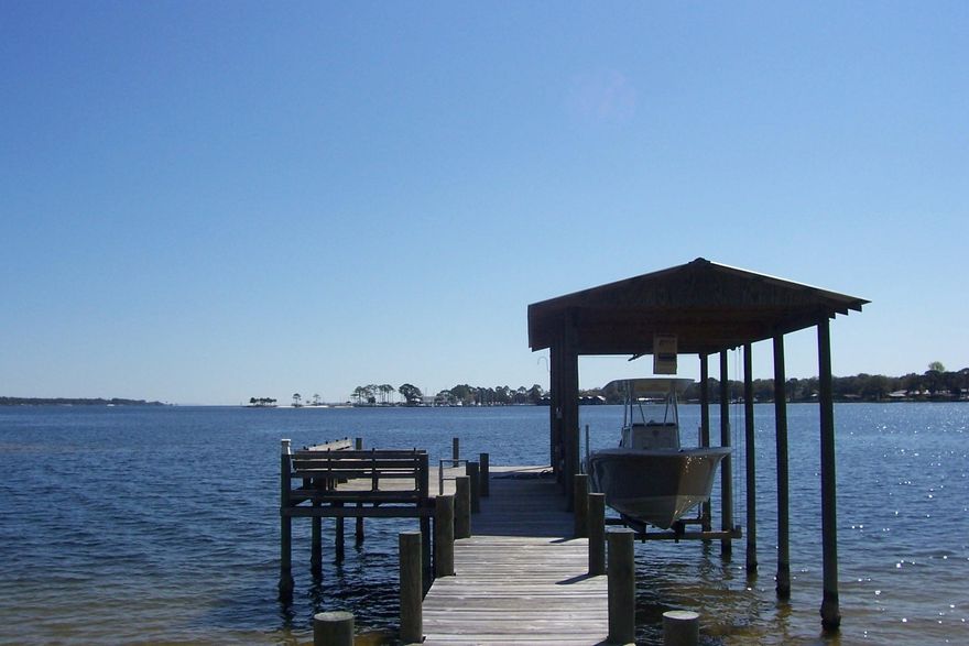 Fantastic Custom Built All Brick Home! Waterfront on Bay with unbelievable views. This Open concept plan centers on Family/Kitchen/Dining area utilized to fullest. Split level floor plan. Office/Bedroom offers a full bath near by. All Bedrooms and living room are hard wired for internet and cable. Features Bull nose corners, Tray ceiling in Master with rope lighting, Sink in Laundry room and garage, Fixed/wide stairs to Attic above garage. Heavy gage metal roof. Blown cellulose Insulation in walls. Icynene insulation. Central Vacuum installed and available. Soft closed drawers in kitchen. Stainless steel outdoor shower, 72 Gallon hot water Tank, Manabloc water distribution manifold. Dual AC/Heating. Dock with boat lift & electric/water. 10' depth at end of dock. Boaters Dream!