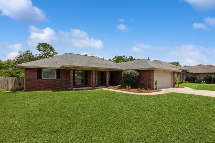 This spacious, all-brick home features an open-concept, split floor plan for the 3BRs, 2 baths & flex room. Dramatic, bamboo hardwood flooring throughout, FRESH interior paint!  Kitchen highlights include granite countertops, breakfast bar & ample cabinet storage! Newly painted deck, FRESH landscaping & fully-fenced backyard! Property goes beyond fence & includes the creek! Underground irrigation system on private well!  Only minutes from shopping, dining, Navarre Beach, Pensacola Beach--don't miss the Blue Angels show!  Short commute to Hurlburt and Pensacola NAS! Be east or west quickly via East Bay Blvd!