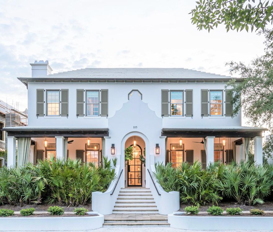 This Stunning Alys Beach villa designed by Cooper Johnson Smith Architects exemplifies a quintessential coastal retreat prominently located across from Central Park, the nature preserve, and within steps to Caliza pool. This idyllic lifestyle home offers fortified construction, custom designed interiors, and unique tile finishes throughout. The home was designed with hand-crafted elements to create a refined coastal feel with white oak planked walls in the dining room and champagne peacock pavers throughout the first level, Australian Cypress flooring on the stairs and throughout the second level, oak beams in the master bedroom suite, venetian plaster throughout, a two-car climate-controlled garage, large heated pool, and unparalleled outdoor living area for entertaining. The front elevation of the home is graced with a large veranda porch and lush landscaping. Upon entering the home, you are immediately greeted with a stunning architectural detailed iron and glass front door offering natural light. The foyer leads into the spacious dining room that has been redesigned with beautiful hand-crafted white oak walls that lead into the pristine kitchen with detailed marble tile, professional grade appliances, and custom cabinetry. Just off the kitchen is a small half bath with detailed custom wallpaper, and large laundry with tiled backsplash and additional entry doors. The living room is the main centerpiece of this home with oversized windows that enhance the entire space with natural light throughout the day to showcase the sophisticated coastal interior furnishings. French doors off the living room lead to the expansive courtyard with a custom chic tiled wet bar, tv, gas fire pit, outdoor dining area, and stunning pool with water feature and custom tile. When retreating to the second floor you will find a complete renovation of both guest suites offering private bathrooms. The first guest suite is a true secondary master with sleek architectural iron/glass doors leading into the large walk-in shower. The second suite has been renovated as well to provide a private en suite for guests to enjoy. As you enter the master you are greeted with a vaulted ceiling accented with white oak beams and large windows that provide natural light all day. The true master piece of this suite is the elegant master bathroom accented with unique custom tile, soaking tub, separate floor to ceiling tiled walk-in shower, and a large walk-in closet with custom built-in cabinetry. This home is one of the most photographed (front elevations) in Alys Beach and once graced the pages of Veranda Magazine. This home is a must see.
