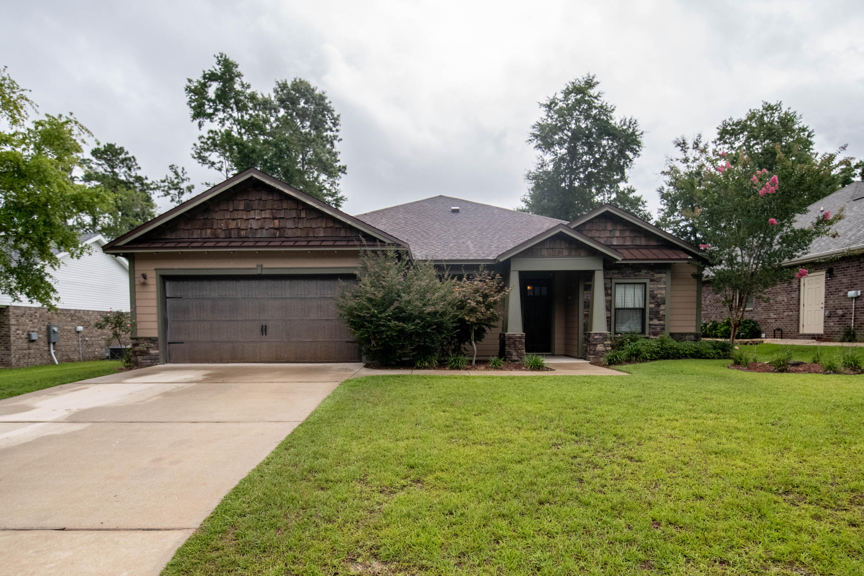Schedule your showing for this custom built 4 bedroom 2.5 bathroom in the quiet and well maintained subdivision of Zachary Estates.This open concept floorplan boats a kitchen with plenty of cabinets and countertop space, and a separate coffee bar that opens up to the large living area with raised ceilings. In addition to the 3 guest bedrooms, the home features a traditional formal dining room and a large master suite with a full 5 piece bath to include separate shower tiled to the ceiling and garden tub.You will love the details throughout the home. The walls and ceilings have been trimmed out with moulding and wood accents.The backyard is spacious and fenced in for with plenty of room for a pool. Cookout at your outdoor kitchen and enjoy all that Florida Summer has to offer!