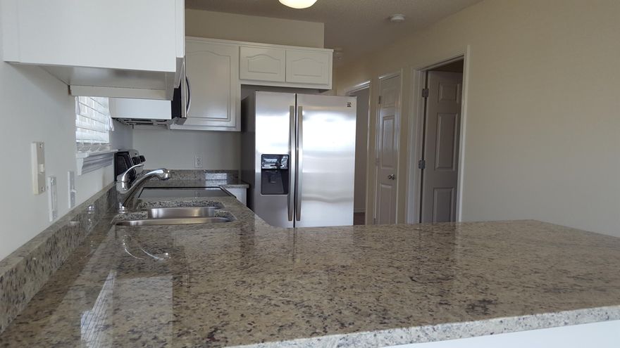 Developer unit!! Like new, completely renovated including granite kitchen counter tops w/under-mount stainless steel sink, all new stainless steel appliances, new faux wood blinds, new sliding glass door blind, new paint thru-out. Beach access is directly south of community. Nice community pool with showers and restrooms. Association provides basic cable, trash and grilling area....GREAT NEWS; We are now VA approved !!