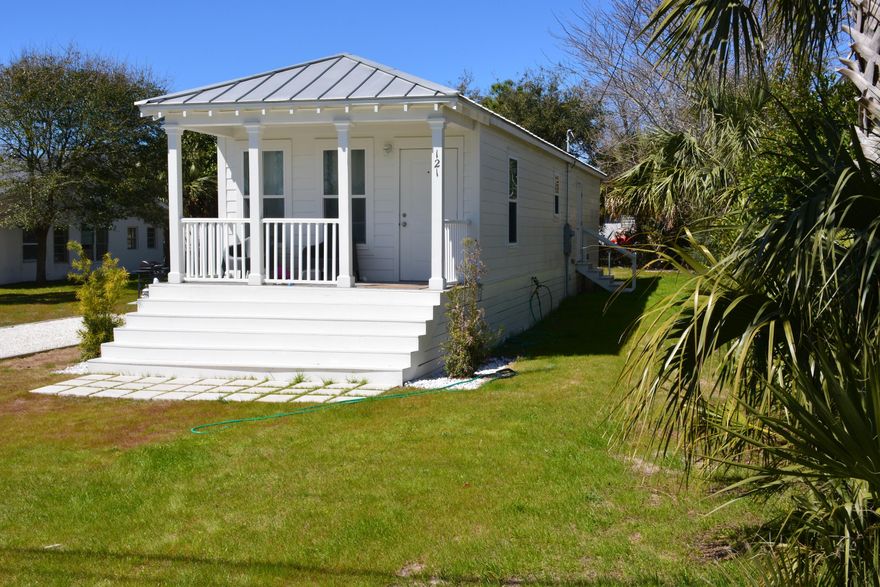 Adorable ''Katrina Cottage'' on large lot less than 300 ft from the beach. If you're unfamiliar with these cottages, the Katrina Cottages was the brain child of a couple of talented architects in response to the substandard FEMA trailers that were used to house families following Hurricane Katrina. These cottages are constructed in a large warehouse in weather controlled conditions and transported to the site where they are set on a foundation. These cottages are classified as standard ''stick built'' homes but because they are transported from the factory to the site, they are required to meet building standards that EXCEED the standards had the home been built on site. Because of the diversity and quality of these cottages, they have become a huge part of the Tiny House Movement.