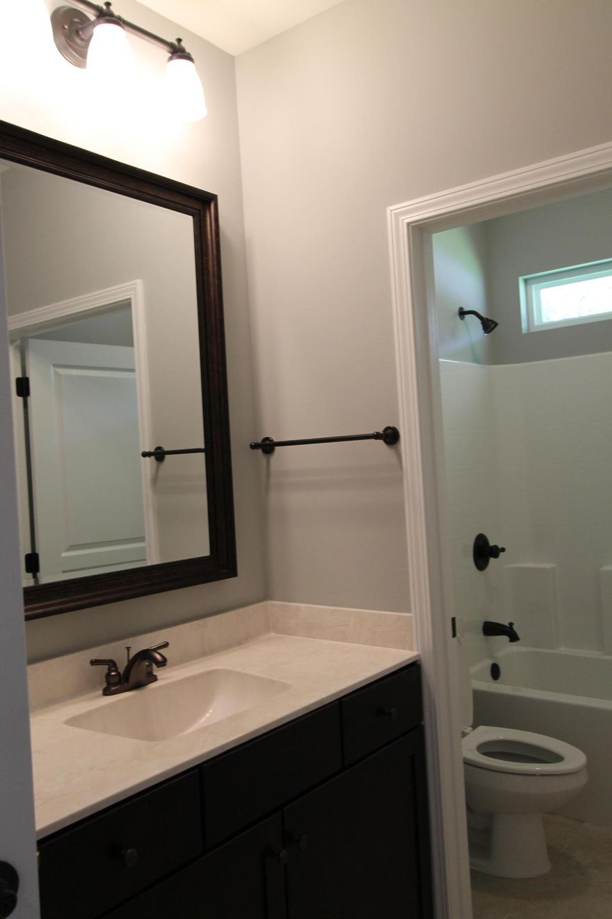 The 4/4, which is built to Earth Cents energy standards, has terrific curb appeal . Location, location, location. As you enter the front of the home through the large covered porch, you will enter the foyer, and bedroom one is tucked away on your left. As you continue down the hallway, the kitchen is on your right and the dining room is on your left. The kitchen boasts custom cabinetry with crown moulding and plant ledges, 3 CM. Granite countertops, Frigidaire Gallery series stainless appliances {including a commercial grade refrigerator/ freezer),and roomy breakfast bar. The greatroom is located at the rear of the home and opens to a large patio which is perfect for entertaining. The master suite is located at the right, rear, of the home and has 2 large walk - in closets, double vanities, whirlpool bath with separate shower with glass enclosure and a linen closet. The upstairs 2 roomy bedrooms each with separate full baths and walk in closets. Home has a Taexx ,''in the wall'', pest control system that is serviced from the exterior of the home, for owner's convenience. Yard is fully fenced and boasts mature trees. The yard is beautifully landscaped, and come complete with a sprinkler system, well, pump and timer.