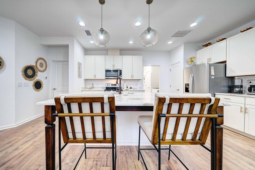 Welcome to Coral Reef Way, where resort-style living meets refined coastal elegance. Premium Upgrades. 2-bedroom | 2-bath Camellia Cottage is available for purchase. Offering every detail you've been searching for, from its prime location near to world-class amenities, to its impeccable interior finishes. Step inside to discover an open-concept floor plan adorned with luxury plank flooring throughout and anchored by a stunning quartz extended kitchen island. The gourmet kitchen showcases upgraded cabinetry, designer wall tile, creating the perfect space for both entertaining and everyday living. Retreat to your spacious bedrooms, each designed for comfort and privacy, while upgraded baths feature elevated tile work and modern finishes. The epoxy-finished garage adds both function and polish. 
Outside your door, Latitude at Watersound Margaritaville offers a lifestyle like no othermultiple resort-style pools, pickleball, fitness centers, waterfront restaurant, live entertainment, planned activities, and so much more. Future amenities include a marina on the Intracoastal Waterway ensuring endless ways to embrace the coastal lifestyle. Plus, you're just a short drive from the sugar-white sands and turquoise waters of the Emerald Coast. This is more than a homeit's a 55+ luxury community experience that blends relaxation, recreation, and connection.