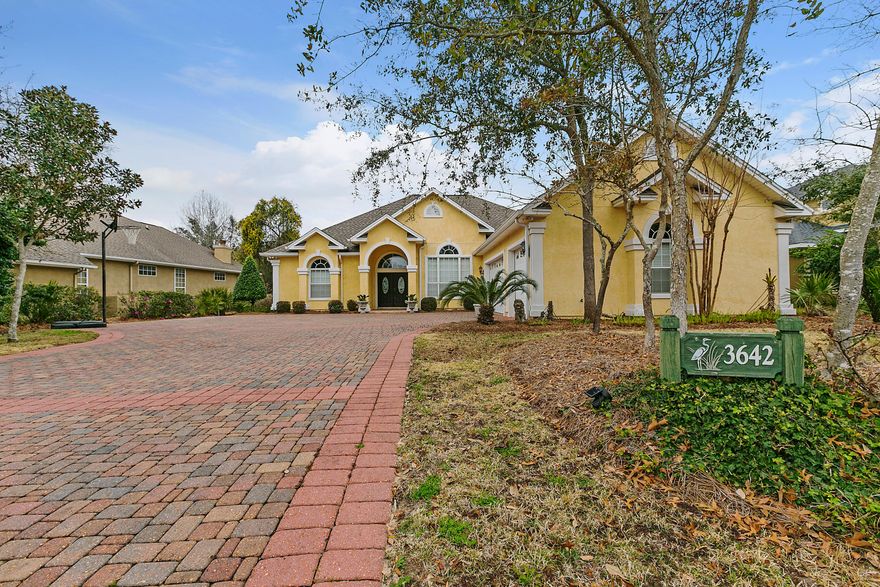 Beautiful custom built home, by a local quality builder, in the coveted gated neighborhood of the Preserve On The Bay. This home upon entering, features an open area floor plan with 12ft ceilings in the foyer and dining area with heavy crown molding, columns and wainscot and hard wood floors in the dining area, a large open living area with beautiful custom built gas fireplace with deluxe trim and granite surround and also deluxe base boards and 10ft ceilings throughout the home. The kitchen area features custom built cabinets, granite countertops, bar, under cabinet lighting, tile floor and breakfast nook with bay window that opens to a large covered porch and large back yard with plenty of space for a pool/hot tub. A private fence runs along the back of the yard which includes