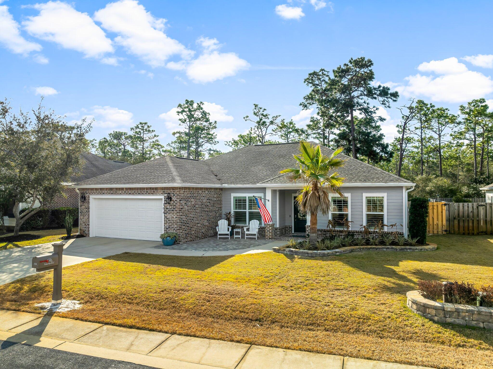 Practically new one-story home in Forest Park, backed up to the preserve! Lightly lived in, this residence features new landscaping, a split floor plan, LVP flooring, plantation shutters, and recessed lighting. The gourmet kitchen boasts granite countertops, a double oven, a Miele dishwasher, a separate under-counter ice maker, and a walk-in pantry. The master suite includes a luxury open-concept walk-in shower with dual shower heads. Outdoor living shines with a covered paver patio, outdoor kitchen, and fenced yard. Additional highlights: two-car garage with mini-split A/C, tankless water heater, and a CASPR air purification system. Located in a peaceful, no short-term rental community offering privacy, a tight-knit neighborhood feel, and close to schools, parks, shopping, and beaches.