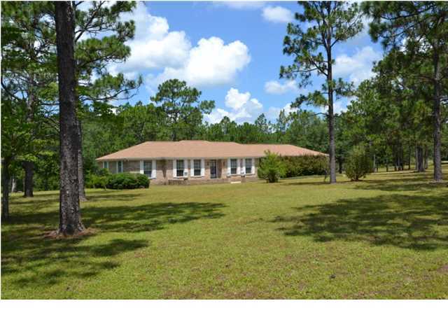 Spacious Ranch style home on almost 5 acres of land...plus the seller will pay $4,500 toward closing costs for you! This all brick home has a lot of features you might be looking for: From the front Courtyard, step into the Foyer and you will see the beautiful hardwood flooring in the Foyer, Living Room, Dining Room, Family Room, Hallway and Breakfast Nook. The Family Room has a beamed cathedral ceiling and center fireplace. The Kitchen comes fully equipped with all appliances, oak cabinets galore, tile flooring and tile counters and adjoining bay windowed Breakfast Nook that opens to the 34x12 wood deck, overlooking the back yard landscape. Any repairs required by appraisal to be paid by buyer. Home is being conveyed in its ''AS IS'' condition...for the repairs needed, please see