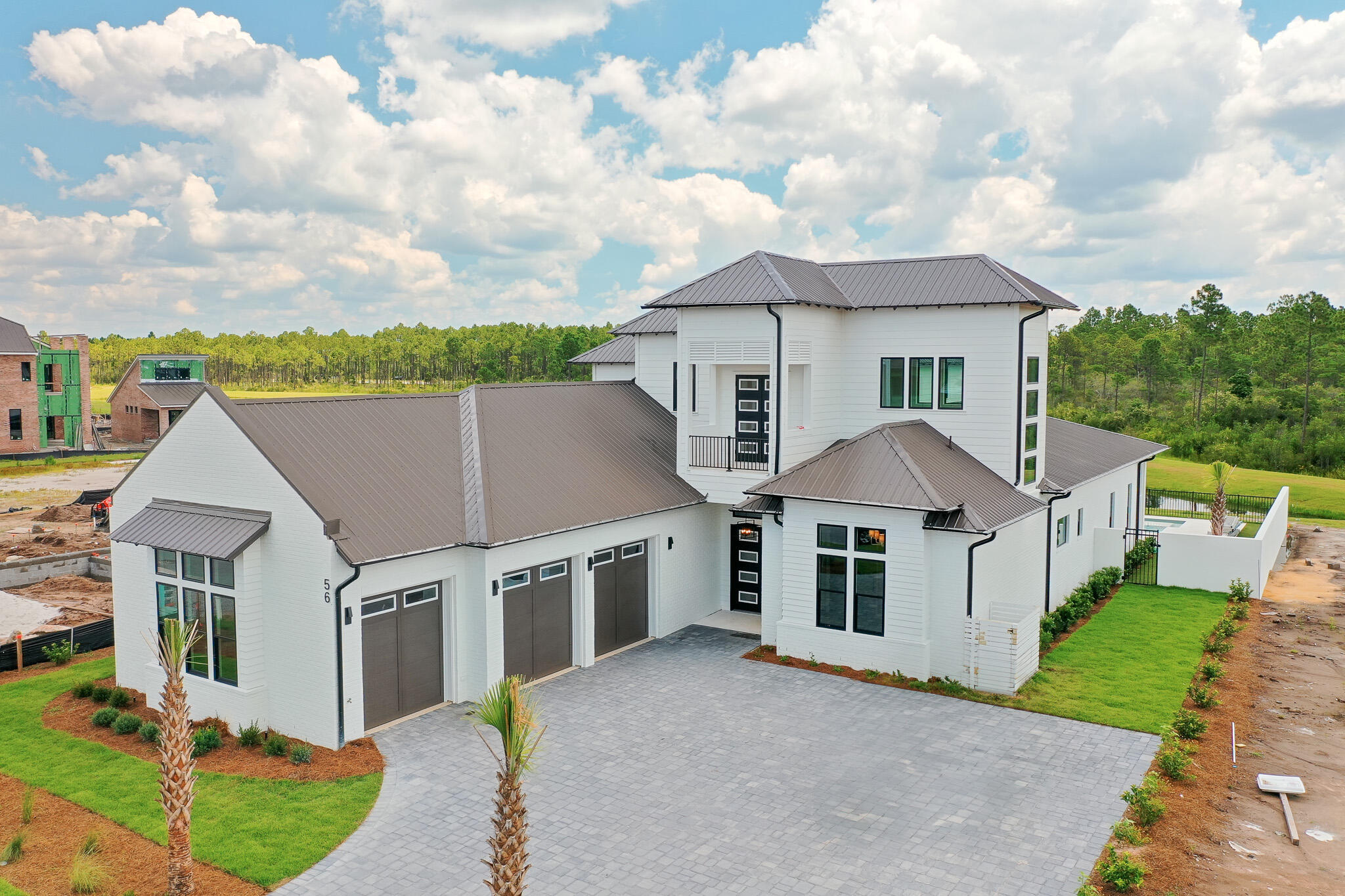 Designed by renowned architect John Williams, this elegant new construction--nestled behind the private gates of Camp Creek--showcases impeccable craftsmanship paired with refined coastal charm throughout. The kitchen is a chef's dream, featuring custom-milled cabinetry, an expansive island, quartz countertops, and a luxury appliance package complete with a gas range. Flowing seamlessly from the kitchen, the spacious living and dining areas provide direct access to a covered porch with an outdoor kitchen, blurring the lines between indoors and out to create a continuous space for both relaxation and entertaining.