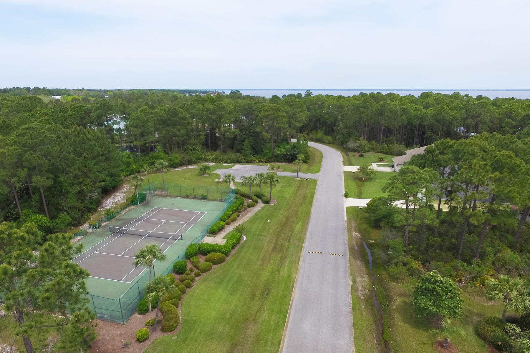 Prime homesite in the Pelican Bay neighborhood of Santa Rosa Beach is located across the street from the neighborhood tennis court. Pelican Bay is a gated neighborhood that offers additional amenities that include a Bay-front park and neighborhood dock.