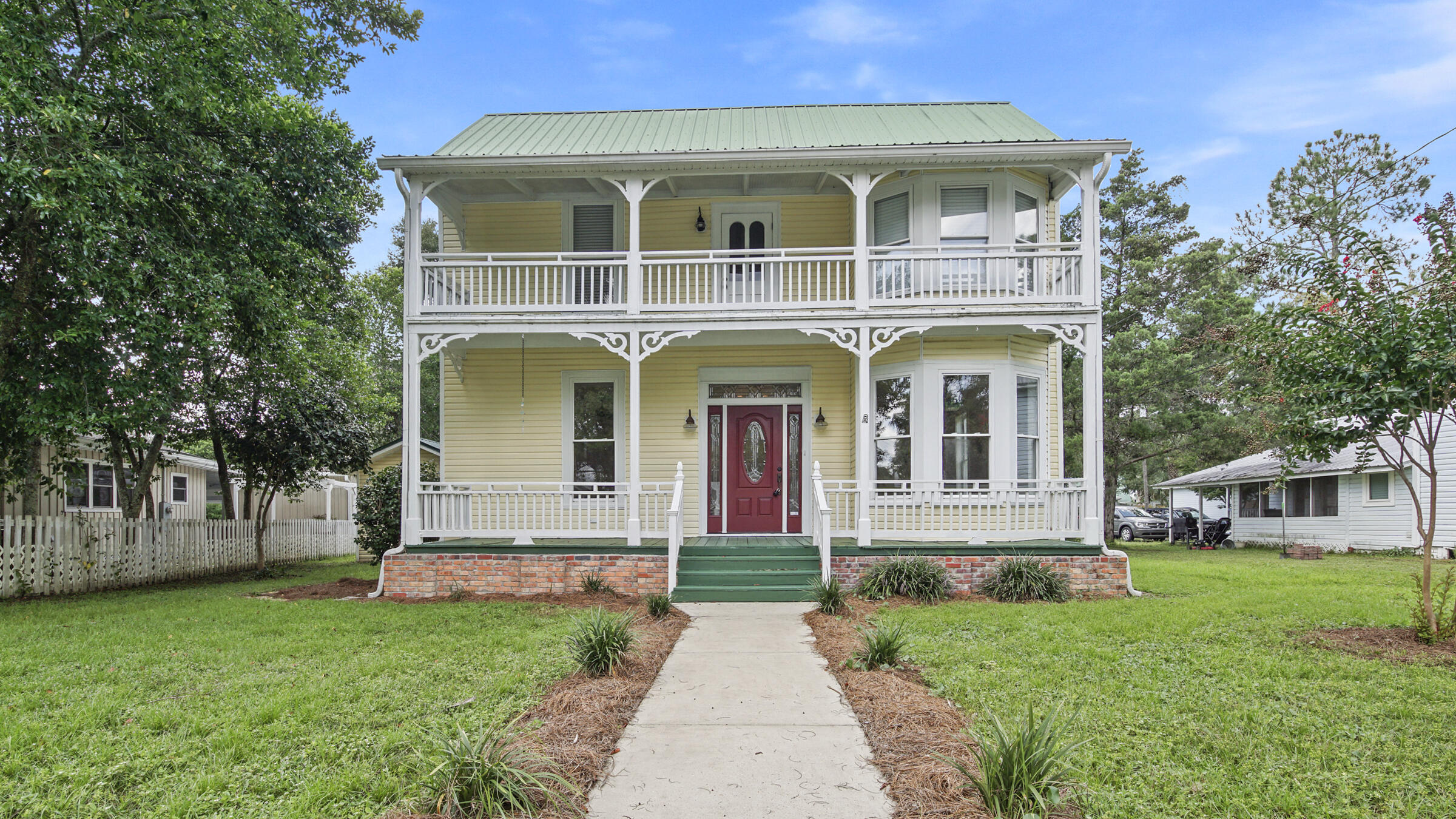 'So THIS is where they keep all the light!' (bonus points if you know the movie) You won't wonder where any longer after visiting this perfectly appointed, full of light, historic DeFuniak Springs 1900 era home. Ideally located, just one block from Lake DeFuniak (with new swimming area), tennis courts and walk to lively downtown for restaurants & shopping. Gleaming heart pine floors, crown moulding & gas ready brick fireplace are just a few details that await you. Masterfully designed kitchen with pull out drawers, island, granite counters, under cabinet lighting & instant access to the back screened porch and covered parking. The downstairs bedroom + 1 full bath, could utilize the adjoining living room & function more like a separate living suite. As often is the case with historic home,