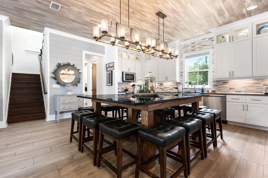 Experience coastal luxury and turnkey profitability with this 5 bedroom, 5.5 bathroom home in the Retreat at Miramar. Built in 2019, this 2,904 sq. ft. residence features an open-concept design with high ceilings, premium finishes, and abundant natural light. The chef's kitchen boasts granite countertops, stainless steel appliances, and a spacious island. Each bedroom includes an en-suite for ultimate privacy. Outdoors, enjoy a private community pool, pavilion with lounge seating, and a landscaped yard. Short distance from the beach, dining, and shopping, this property excels as a short-term rental. Includes all furniture/bedding, golf cart, property management software, guest database, social media content, and materials to ensure a seamless handover.