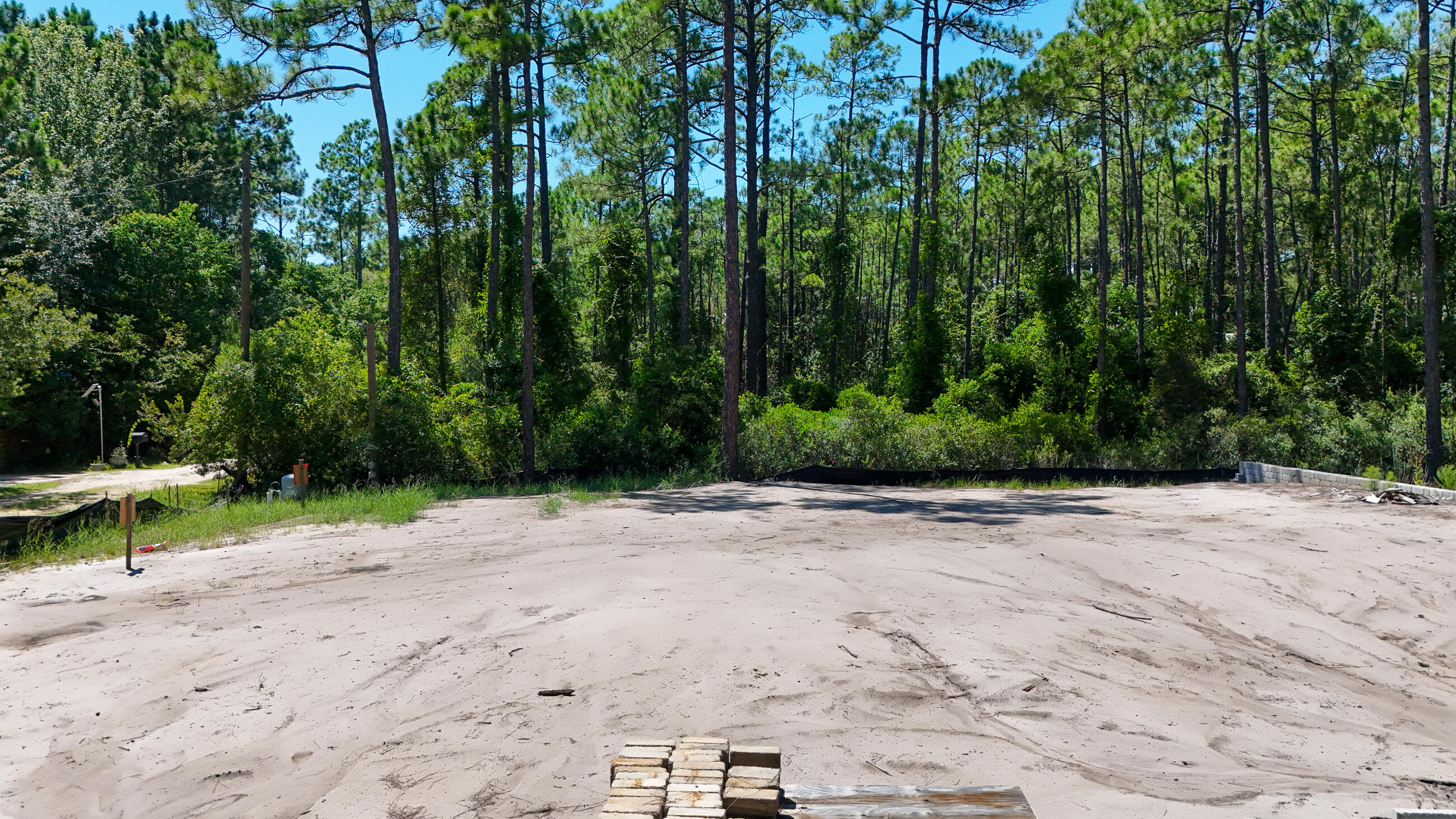 This lot is turn key with building plans all ready in permitting. If you are looking to like within a mile from the Gulf on a private road this is your new home site. Mitigation is completed, survey and building plans available.