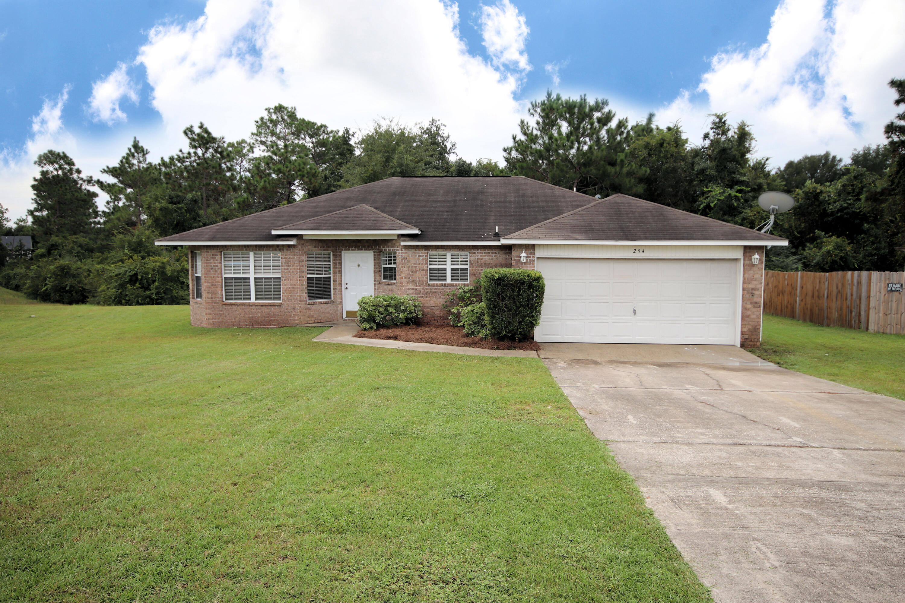 This beautiful home is conveniently located in the heart of Crestview; near schools, shopping with easy access to the military bases & I-10. The home is on one of the largest lots in the neighborhood located on a cut-de-sac at the back of the subdivision. All new LVP flooring and new carpet in the bedrooms was just installed in the entire home. The interior of the home was completely painted as well. New Roof being installed prior to closing! The large kitchen with rich, dark brown cabinets, a center island and an eat in dining area looks out into the family room. The great room opens up to a wooden deck that looks out over the backyard which is surrounded by natural woodlands.The sizeable master bedroom has an ensuite bathroom, double vanities and his/her walk in closets.