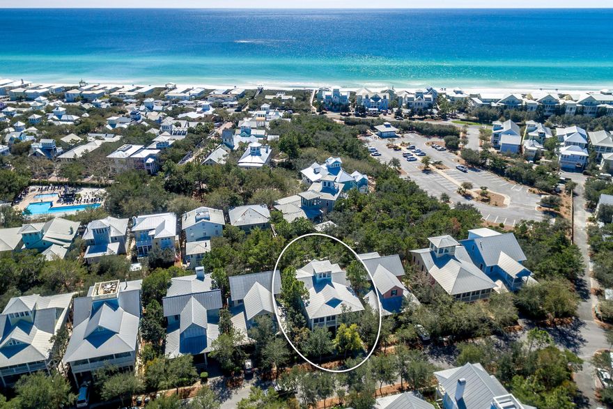 Tucked away in the Park District of the coveted community of WaterColor, this custom-built, 4 bedroom home boasts Gulf views from the third-floor tower & a Bonus Bunk Room! This WaterColor home welcomes you with an expansive front porch, a perfect spot to enjoy alfresco dining and double door entry. This beach house offers a SPACIOUS great room with an open Floor Plan, soaring beamed ceiling, beautiful wood floors & partial wainscoting throughout; making it ideal for entertaining. The kitchen features a center island with granite countertops, breakfast bar seating, a farmhouse sink, & high-end Wolf appliances including a sub zero fridge.The coveted main floor master bedroom offers a private covered porch & attached bath.Also located on the main level is a custom-built office with granite