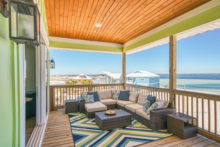 WATERVIEWS..from all rooms to include bathrooms! Views of the Gulf and the sound! Built in 2017 by an award winning builder, this home is an entertainers dream with outdoor kitchen, surround sound system for all rooms including outside decks, attached decks to all of the main rooms, fenced back yard and outdoor firepit. Inside are 5 very spacious bedrooms and 3 1/2 bathrooms with TWO master suites, one on each level.  The spacious and stunning kitchen comes complete with white shaker cabinets, granite countertops, glass tile backsplash, all stainless steel appliances to include a wine beverage cooler and icemaker. The kitchen, dining and living room combination views make you feel like you are on the water, and even in the water!