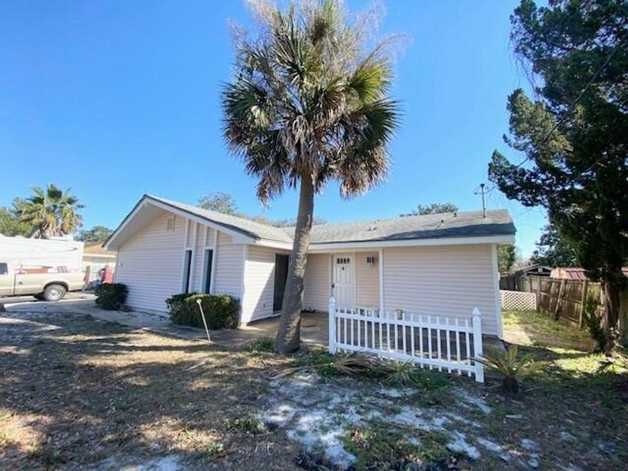 Location, location, location! In the heart of Destin, close to everything! Newer LVP flooring throughout, no carpet! Newly painted interior (neutral gray) & semi-remodeled bathrooms! Cathedral ceilings in the living room w/ an extra sunken extension, could be used as 1 large room or 2 different rooms. Inside utility room w/ washer/dryer included. All electric. Screened back patio great for relaxing/entertaining. Covered front entrance as well w/ another patio area. 2 car garage w/ auto opener & storage closet. Yard building for additional storage as well. Large fenced yard. Extra long driveway for lots of parking &/or RV/boat storage. Call you favorite Realtor today!