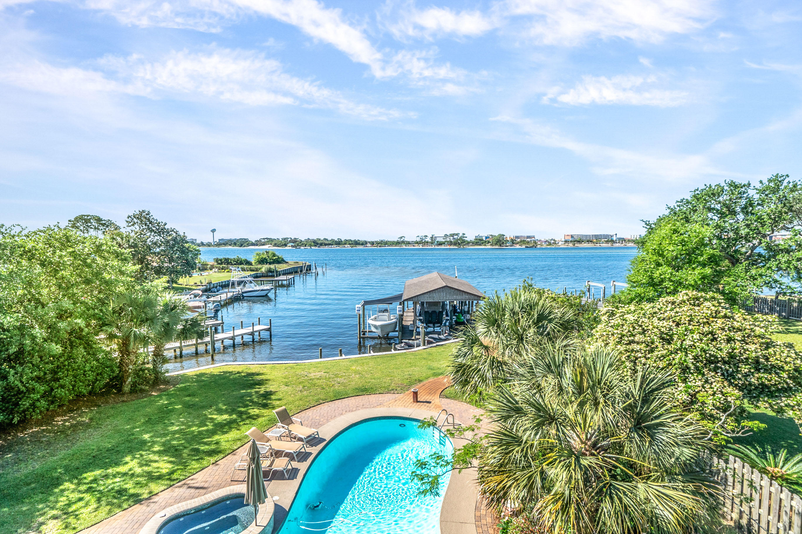 IMAGINE LIVING IN YOUR OWN RESORT! This 6,287 sq ft, Magnificent 5 br 6.5 bath estate property is just that. 123 feet of deep waterfront! From the moment you enter through the dramatic double door entrance you know you have entered an estate built with elegance, style and quality. Once inside the high-beamed ceiling foyer a curved staircase leads to the second level with an exquisite wrought iron railing. Your eyes are drawn thru the soaring Great Room to the panoramic water views of Choctawhatchee Bay. The open floor plan features a massive Great Room, gourmet kitchen and large dining room perfect for family dining or entertaining a dinner party. The kitchen features custom cabinets, all Thermador appliances 2 dishwashers, 2 gas ranges, 3 ovens, food warmer, ice maker and 2 drink coolers