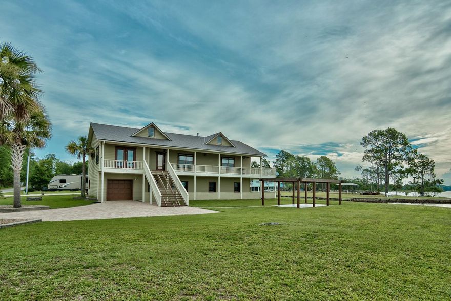 Sold fully furnished. Seclusion at its best! Located across from protected forested military land your sunsets will always be in view. This large and spacious home offers 6 large bedrooms and 4 1/2 bathrooms, water-facing balcony and patio, and beautifully finished rec room with pool table. The property is waterfront with spectacular views of Alaqua Bayou and Choctawatchee Bay. Invite your friends to visit by water, and park their boat at this home's private dock! It also boasts a covered boat lift which accommodates boats up to 30 ft, RV pad.