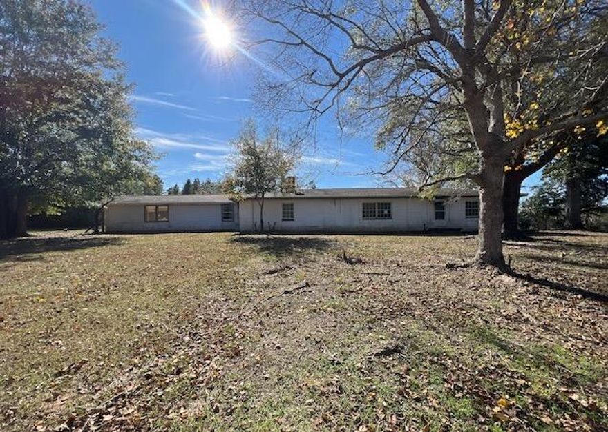 This super unique REO home comes with acreage and must been seen to appreciate. Built in 1963, this concrete block home has 3 bedrooms, 2 baths and is just under 2000sf of 1st floor living space. This a flagpole style lot therefore the entrance to the property comes at the end of a small trail and opens up to the full, nearly 3 acre cleared home site. A traditional styled home, the uniqueness comes with the massive underground storm shelter/basement area. This space is nearly as large as the first floor square footage and is entirely underground. This home needs repairs, therefore, cash or rehab loans only can be used to purchase. Call today!