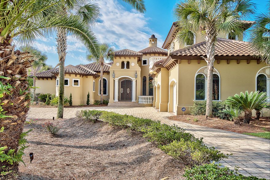 Exceptional opportunity to own this stunning lakefront Mediterranean masterpiece centrally located in the prestigious gated golf course community of Regatta Bay. Located adjacent to the Choctawhatchee Bay, this estate style home features recent upgrades including all new exterior paint and landscaping, new interior paint, surround sound system & custom wood built-ins, new travertine flooring and a luxurious outdoor kitchen. Other notable features include pecky cypress accents, gas lanterns, multiple indoor & outdoor gas fireplaces, executive office space, 30' beamed ceiling in the dining room with 10'-12' ceilings throughout, private wine cellar as well as a single story attached Mother-In-Law suite with private entrance. The chef's kitchen is is draped in luxe finishes including c