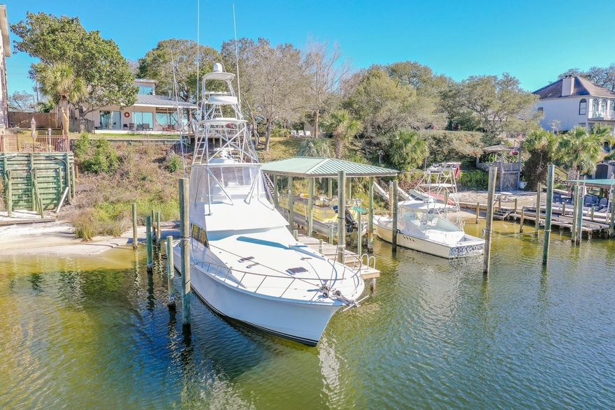 This rare Mid-Century Modern masterpiece on Destin harbor is a gem for the yachtsman as it boasts protected boatslips that can accommodate yachts up to 50ft along with bumper pilings in place to pull up boats that are 60+feet in deep, very calm water. The house, completed in 2016 is a refreshing modern style that brings city elegance to the Destin Harbor. It boasts oversized, impact glass windows that are also tinted! The house sits over 24ft up and well out of harm's way and has incredible seabreezes and sunsets. There are NO HOA or restrictions here, but also no vacation rentals allowed. Enjoy the best Destin has to offer with a great view, central location, and have a water taxi take you and your guests to the harborwalk sites or to the beach. Enjoy a turnkey incredible home in Destin