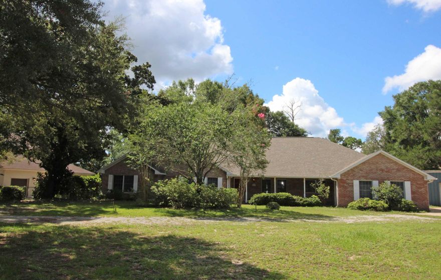 UNIQUE ONE OF A KIND PROPERTY! CUSTOM BUILT WATERFRONT ESTATE SITUATED ON ALMOST AN ACRE IN THE HEART OF NICEVILLE. Spacious living area with high beamed cathedral ceiling, recessed lights, tile flooring, and a lodge style fireplace with extended mantle and hearth for those cozy winter nights. Formal dining area has chair railing and hardwood flooring throughout. Country kitchen with custom oak cabinets, lots of counter space, large window above the sink with incredible water views, butcher block center island with a jenniare cook top and breakfast bar with seating for three, French door leads out to the covered patio and 24ft x 22ft deck area. Breakfast room perfectly placed in a bay window overlooking the backyard with water views. Master bedroom has a separate door that leads out to