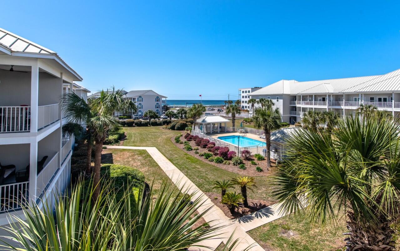 This is a unique condo in Pavilion Palms. Top floor, end unit. Gulf Views. 4 car tandem garage. You can park in the garage and not have to be in the rain to use the steps or elevator that takes you to the front door. Undated unit. 2 newer baths/showers. New water heater. New washer/dryer. HVAC 2016. Large open floor plan and spacious balcony with Gulf Views. Unit has been used by the owner the past 3 years but is being rented, STR,  for the Summer of 2023.