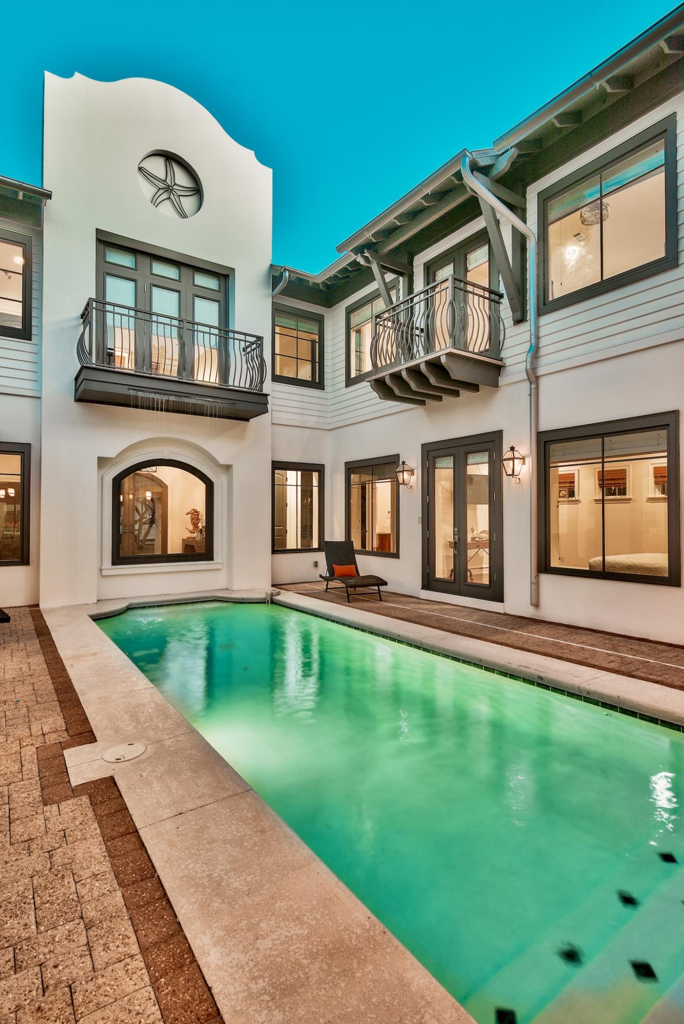 Rosemary Beach at it's finest. Newly listed and fresh off of a complete makeover, this home sits on one of the most abundant lots in the community. The views of the pool and courtyard are simply breathtaking, the pool highlighted by soothing waterfall from the second floor. The courtyard, ideal for outdoor entertaining, features a fabulous outdoor kitchen, a dining area highlighted by an outdoor fireplace, and a lounge for sun bathing. The interior of the home provides fabulous views and private entries to the pool from various rooms throughout. The first floor living area and kitchen again provide the perfect elixir for entertaining, very spacious and open. Brazilian hardwoods throughout, and freshly painted walls create a dramatic affect throughout. With 7 bedrooms (one has no closet),