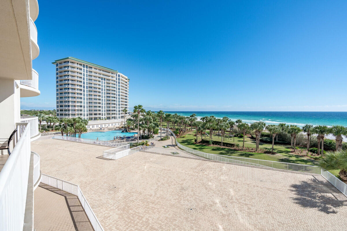 This beautiful gulf front unit is located in St Maarten at Silver Shells. Unit 404 is located in the desired center stack of the building, that offers unobstructed panoramic views of the pool area and the beach / gulf. The level of this unit offers perfect views of palm trees, white sand, and blue water. This unit just had a major remodel, in 2022, that removed walls to offer an open living concept, new cabinets, granite tops, tile flooring that looks like hardwood throughout the unit (not a vinyl plank), and lots of new furniture and appliances. A semi-private elevator opens directly into the unit and the unit has an assigned parking space, in the garage, just steps away from the elevator. The gulf front primary bedroom has direct access to the balcony, with beautiful views of the beach .