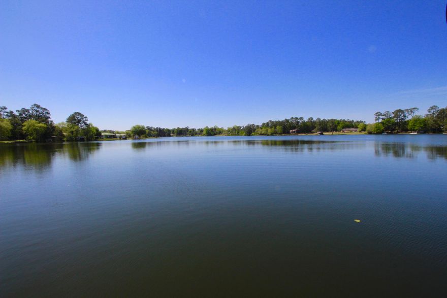 Bring your skis, jet skis, boats & inner tubes! Or at least bring your coffee mug for back porch tranquility. Gorgeous lakefront home on hugely popular Back Lake in the city of DeFuniak Springs. Beautifully updated with new paint, new wood laminate floors in the family and master suite. Kitchen has custom cabinets, double pantry cabinet and granite tops with a raised breakfast bar, perfect for casual dining. Formal dining room off the kitchen leads to the other 3 bedrooms and full bath. Must see 24x14 master suite with sitting area has front row views of Back Lake. For my fellow shoe collectors, there is a 19x7 walk-through master closet leading to the master bath - complete with double vanity, corner tub and walk in shower. Room for a pool in the back yard also!