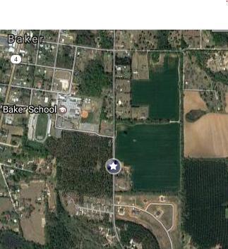 28+ acres. The property has an ideal location, right across from Baker School. The land is cleared and leveled. Features paved road access maintained by the county. The following utilities are available including electric, water, cable, internet and phone. The property is zoned for .25 acre lots.